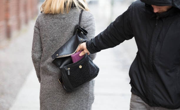 Close-up Of A Person Stealing Purse From Handbag