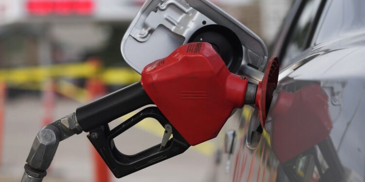 FILE - A motorist fills up the tank on a sedan, on July 22, 2022, in Saratoga, Wyo. Gasoline prices are sliding back toward the $4 mark for the first time in more than five months — good news for consumers who are struggling with high prices for many other essentials. (AP Photo/David Zalubowski, File)