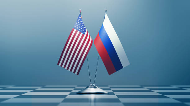 American  and Russian flag pair on a chess board. Horizontal composition with copy space and selective focus. Dispute concept.