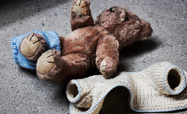 Stripped teddy on concrete floor