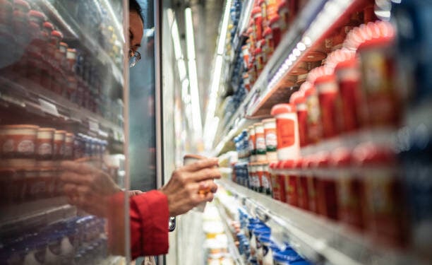 Senior woman buying diary product in the supermarket