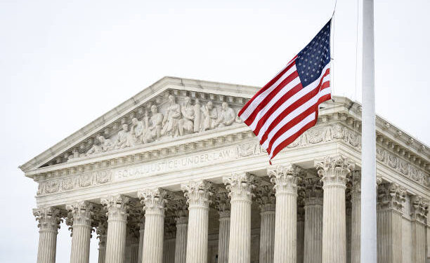 A picture of the supreme court, with the US flag waving in front of the phrase "Equal Justice Under Law"