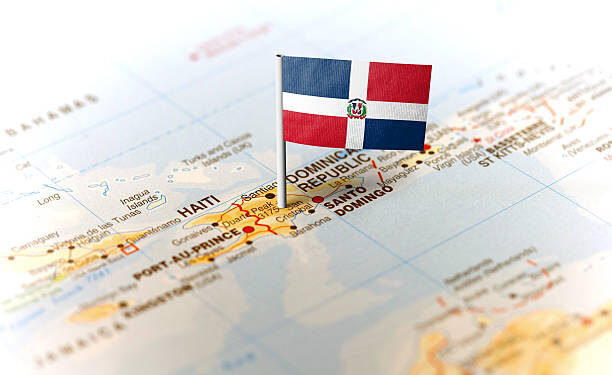 The flag of Dominican Republic pinned on the map. Horizontal orientation. Macro photography.