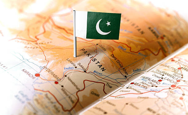 The flag of Pakistan pinned on the map. Horizontal orientation. Macro photography.