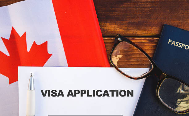 Flag of Canada, visa application form and passport on table
