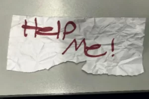 En esta fotografía sin fecha proporcionada por el Departamento de Justicia de Estados Unidos muestra un letrero con el mensaje "¡Ayúdenme!" utilizado por una niña de 13 años que fue secuestrada en Texas.