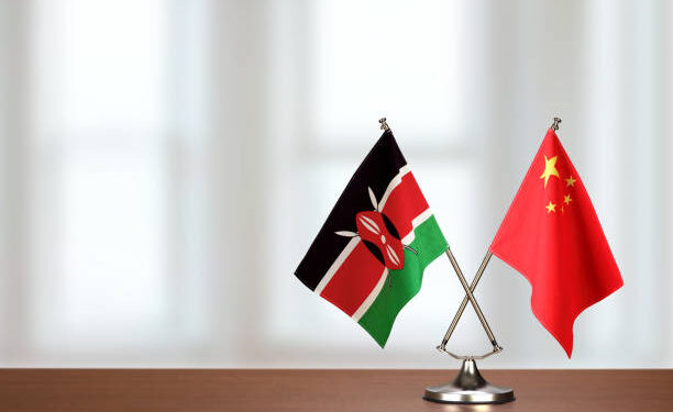 Two crossed national flags on wooden table