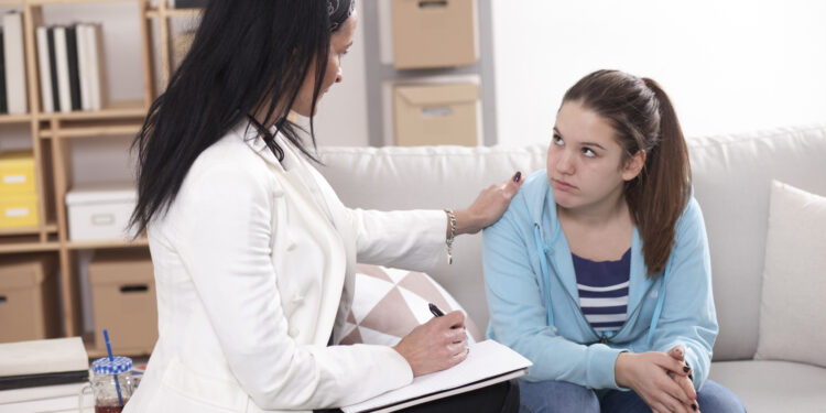 Young teenage girl with psychologist on therapy