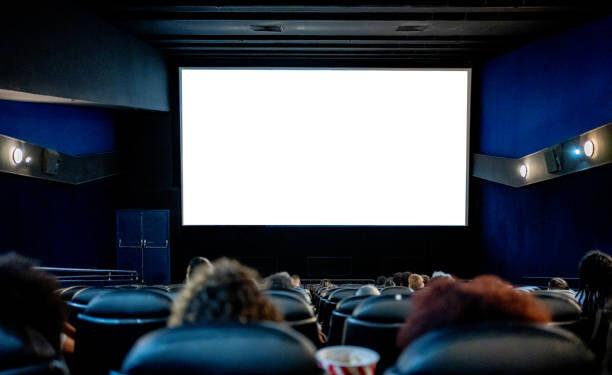 People watching at the cinema, white screen