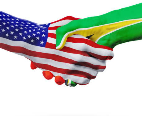United States and Guyana, countries flags, handshake concept cooperation, partnership, friendship, business deal or sports competition isolated on white