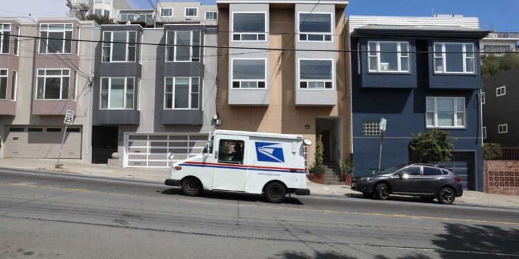 A USPS truck travels up the street from Scott Pluta and his wife Rosalind Pluta's property in the 4000th block of 17th St. on Wednesday, August 25, 2021, in San Francisco, Calif. The couple owns a large lot in San Francisco and is keenly aware of the city's housing crisis. Scott Pluta has been trying for two years to get city permission to build four small units on the lot and has made almost no headway. He down-scaled the project and will go before the planning commission yet again in September.