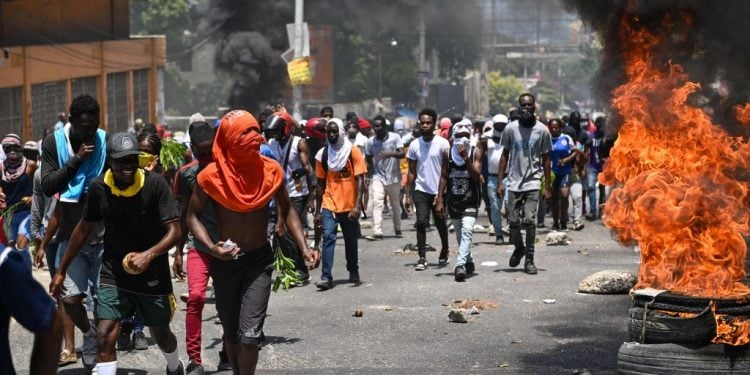 People march as tires burn during a protest against insecurity, on August 7, 2023, near the Prime Minister's official house in Port-au-Prince, Haiti. Some 300 women and minors were kidnapped in Haiti by criminal gangs in the first half of this year, UNICEF said Monday, warning of a disturbing rise in abductions that leave "deep physical and psychological scars."
The surge in abductions threatens "both the people of Haiti and those who have come to help." (Photo by Richard PIERRIN / AFP) (Photo by RICHARD PIERRIN/AFP via Getty Images)