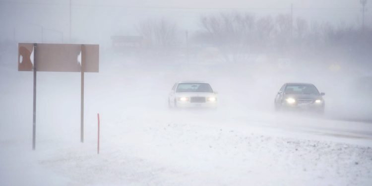 RUDD, IOWA - NOVEMBER 27: Snow blows across a road on November 27, 2019 near Rudd, Iowa. A winter storm, which dumped rain, ice, snow and brought high winds into much of the upper Midwest, has been hampering holiday travel by road and by air on one of the busiest travel days of the year.   Scott Olson/Getty Images/AFP