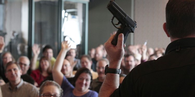 WEST VALLEY CITY, UT - DECEMBER 27:  Firearm instructor Clark Aposhian holds a handgun up as he teaches a concealed-weapons training class to 200 Utah teachers on December 27, 2012 in West Valley City, Utah. The Utah Shooting Sports Council said it would waive its $50 fee for concealed-weapons training for Utah teachers.  (Photo by George Frey/Getty Images)